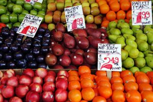 fruit on fruit stand - oranges nectarines apples pears plums